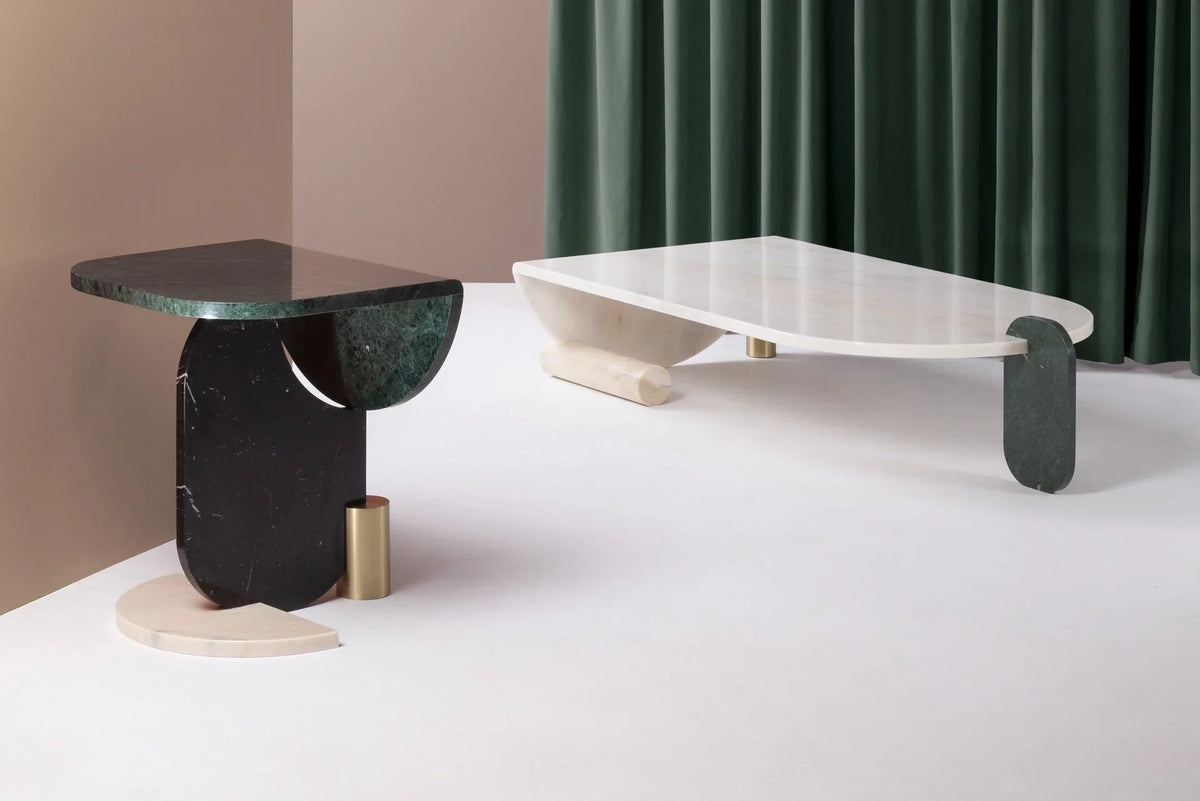 Green marble side table beside a low white sculptural coffee table