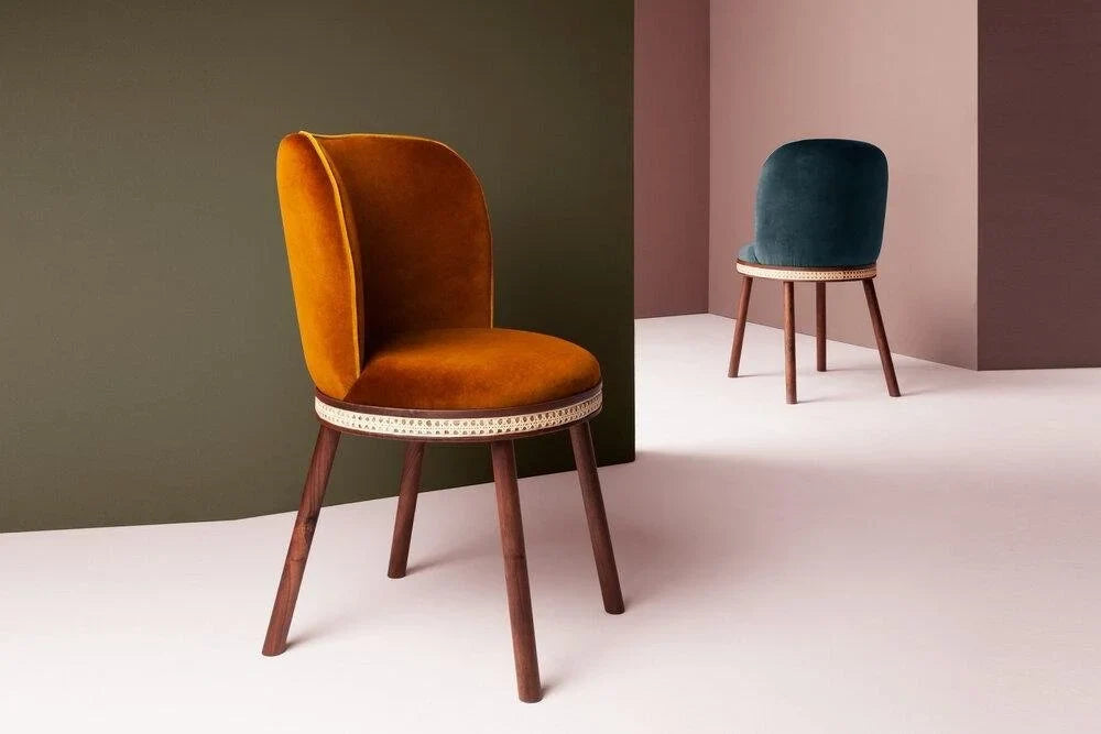 Ochre velvet dining chair and teal velvet dining chair on walnut legs