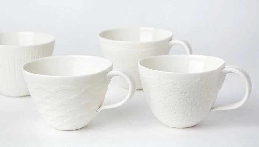 White embossed porcelain cups