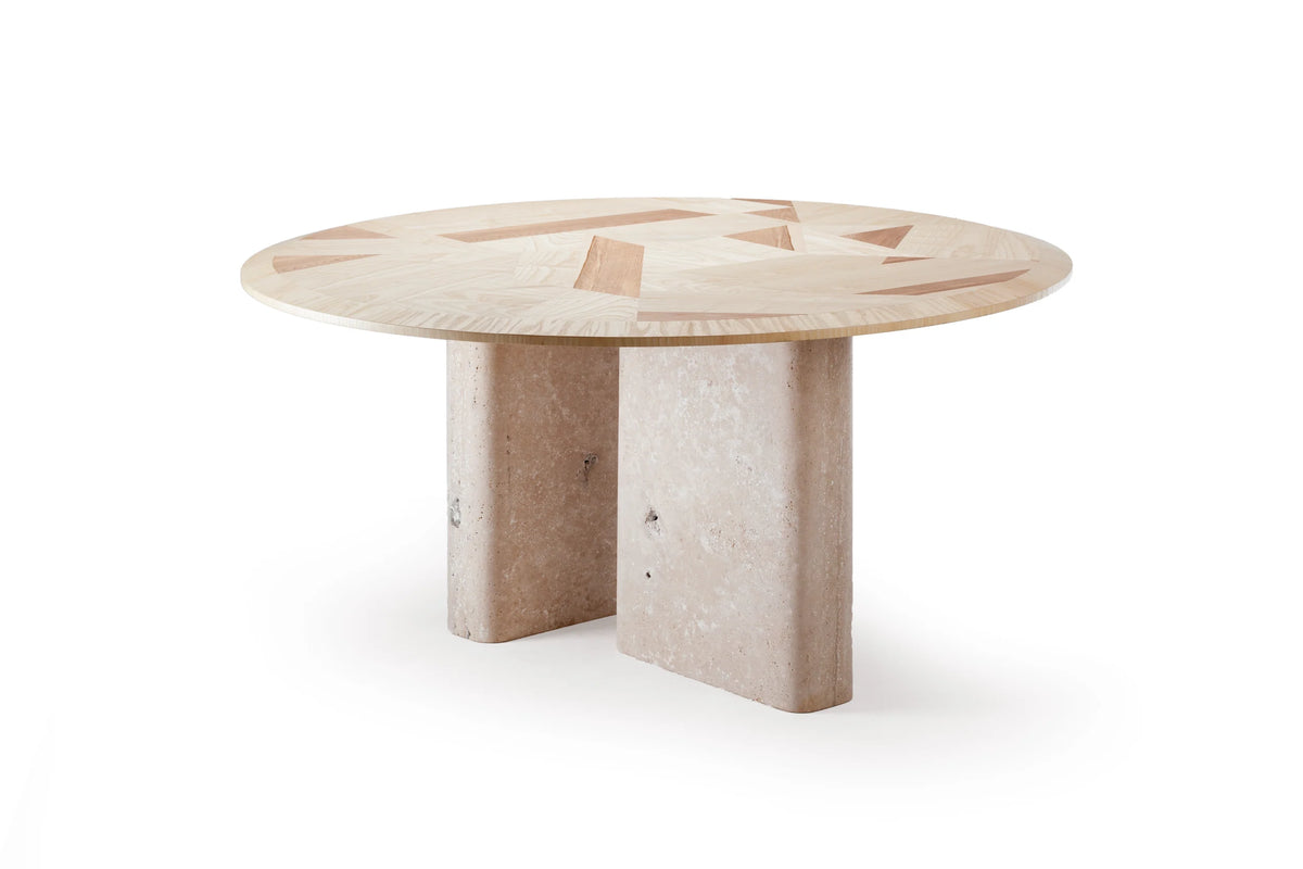 L’anamour dining table with a marquetry top on stone column legs