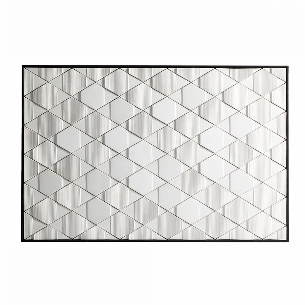 White geometric relief wall art in a black frame