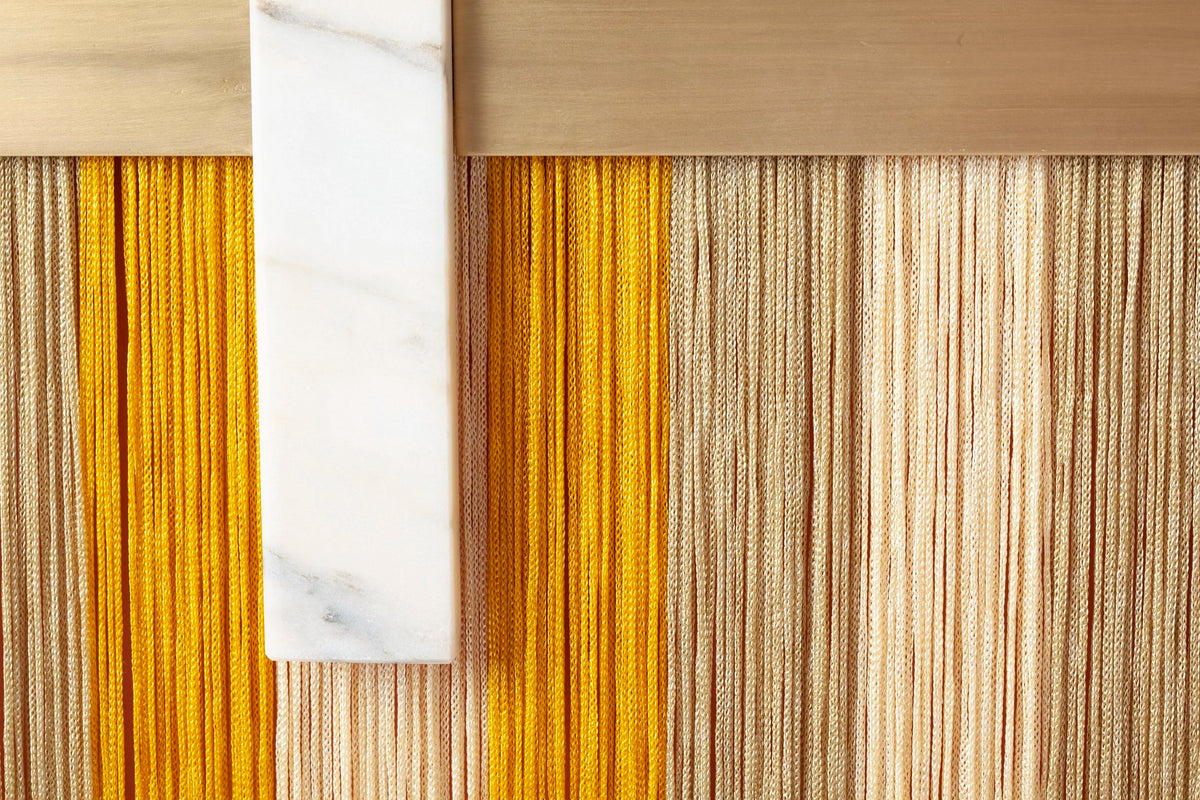 Souk Mirror Yellow detail of golden fringe and white marble bar