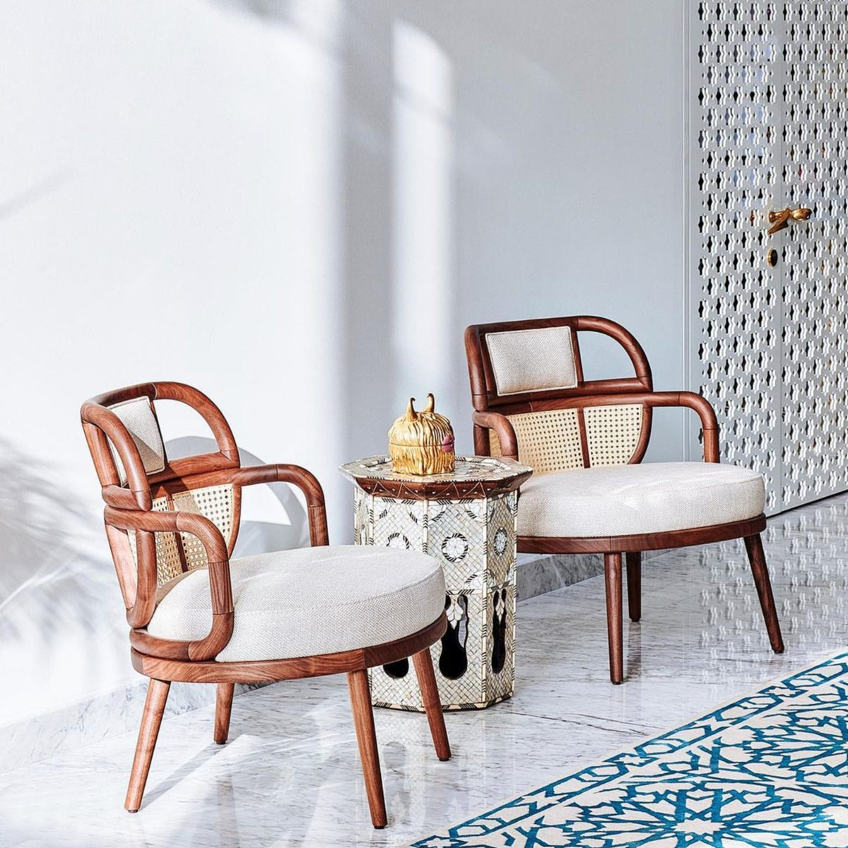 Havana Armchair pair with white cushions on a patterned tile terrace
