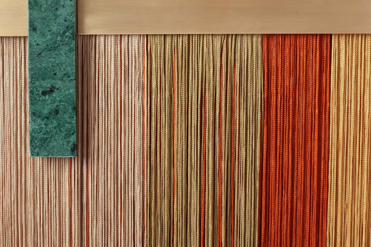 Souk Mirror Red close-up of the green marble bar and fringe detail