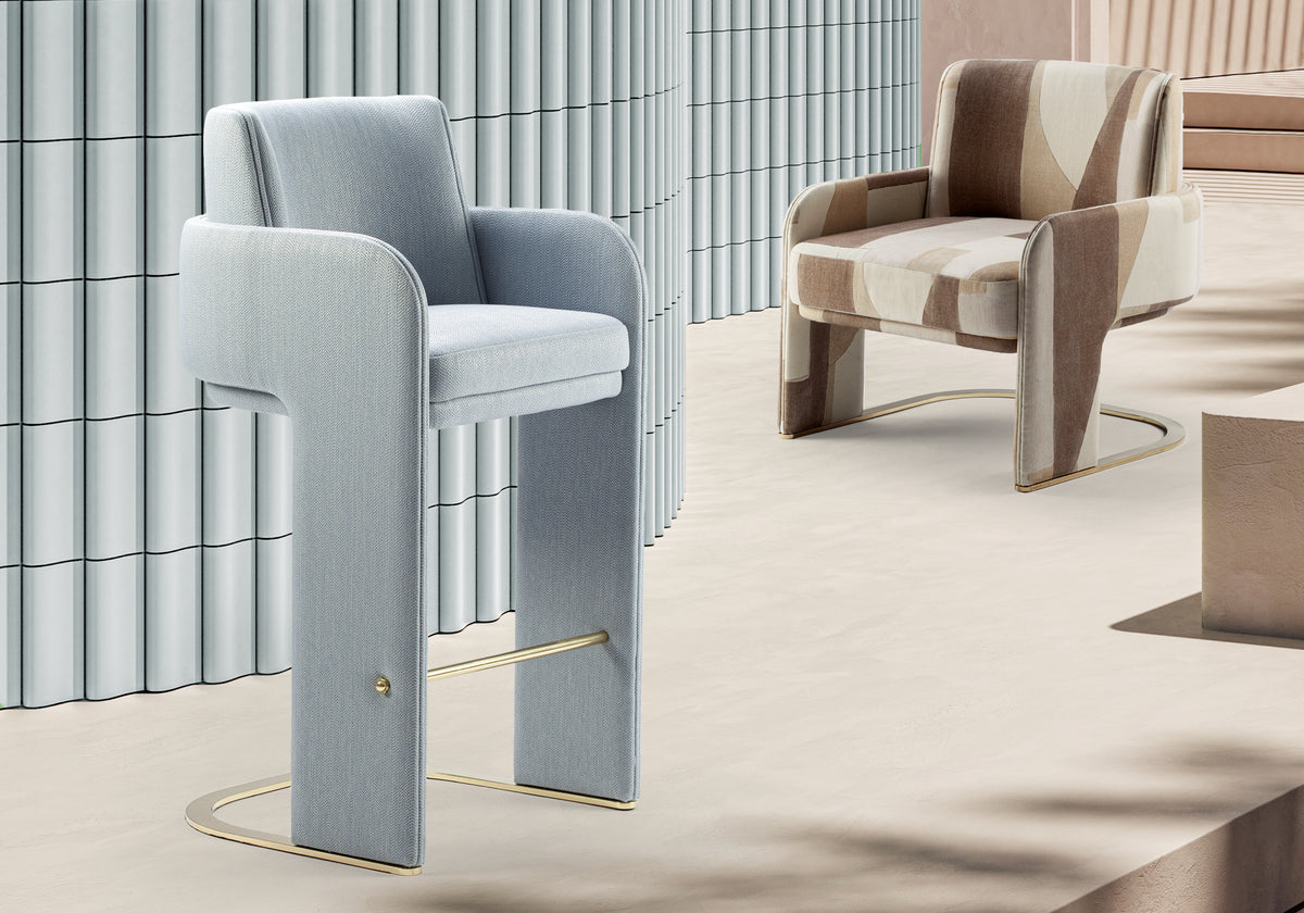 Odisseia Counter Stool in pale blue beside an armchair and fluted wall