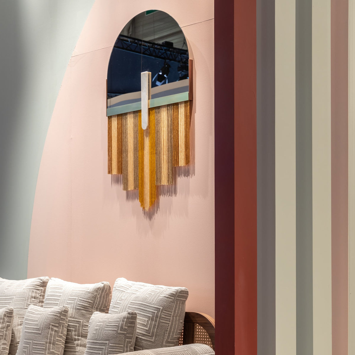 Souk Mirror Yellow on a pink wall above a cream sofa