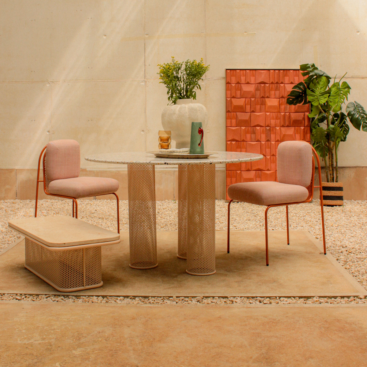 Riviera Dining Table with blush chairs and a low bench in a styled set