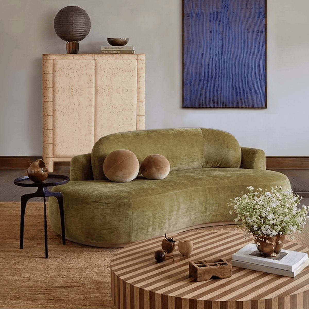 Nusa Coffee Table beside a green velvet sofa in a living room