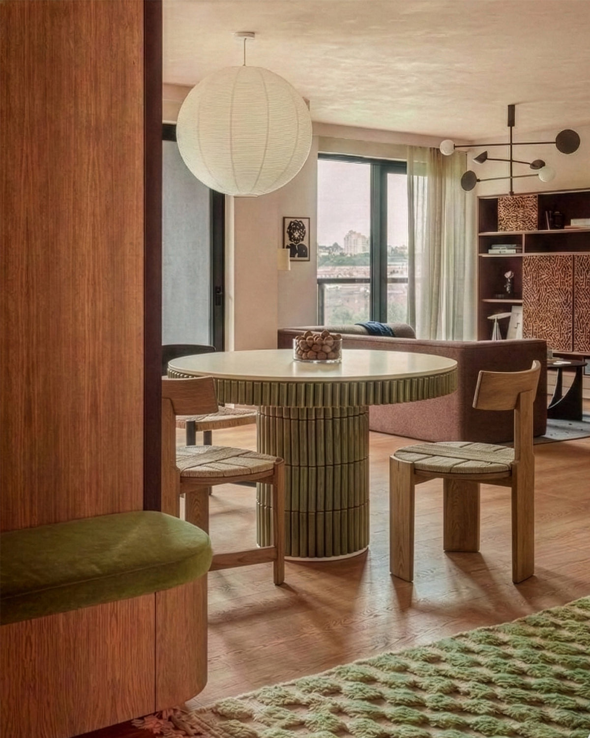 Nest Dining Chairs at a round fluted table in a warm wood-panelled dining room
