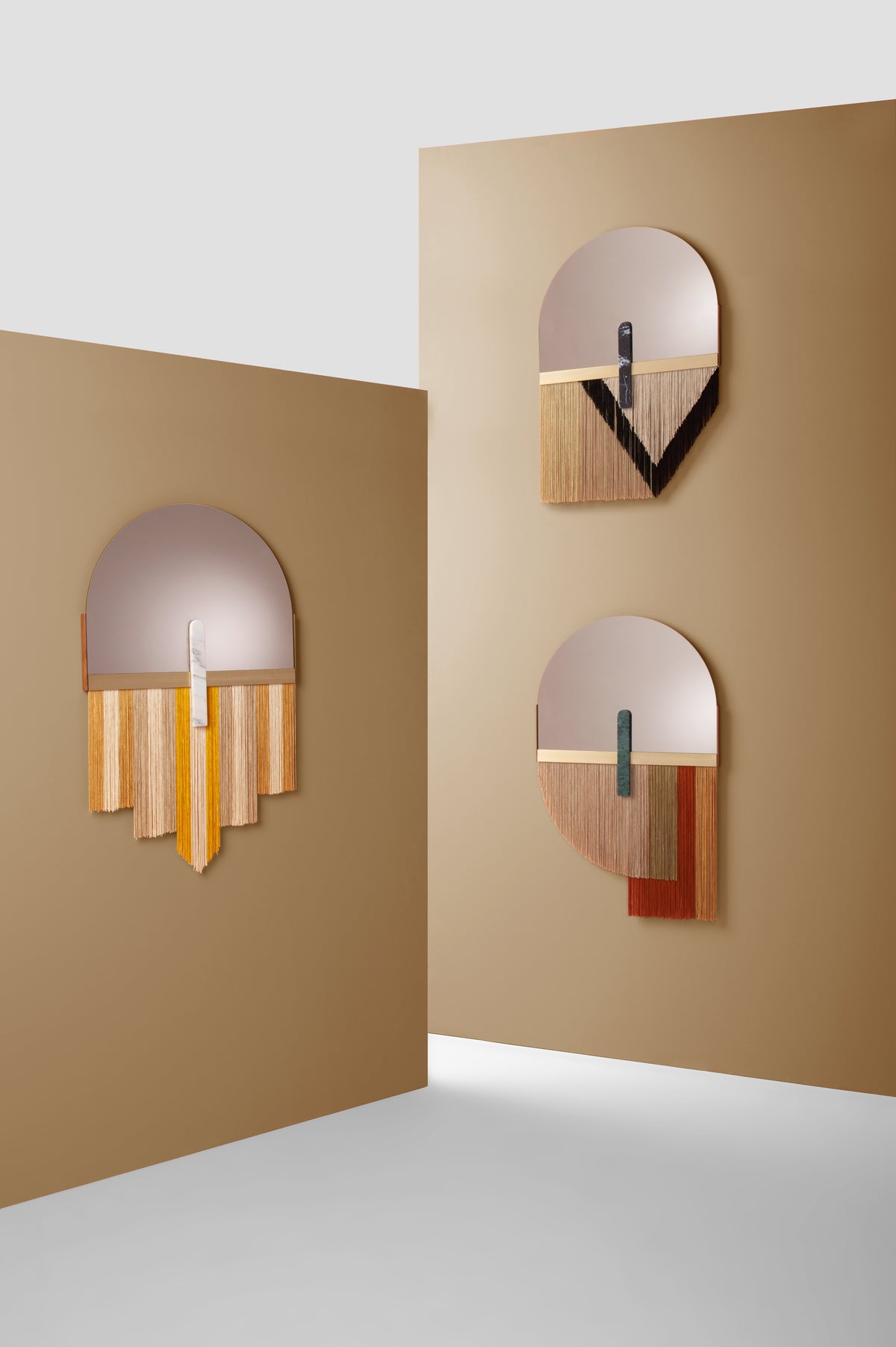 Souk Mirror Black with yellow and red versions on tan display walls