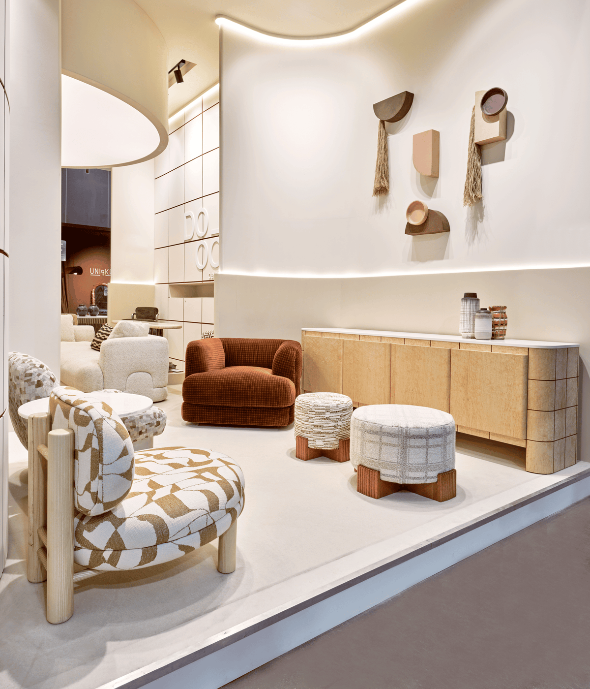 Mosaico Armchair in rust velvet in a cream showroom with stools and patterned seating