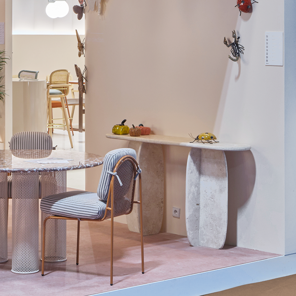 Catus Marble Console Table in Travertine in a showroom with a dining set