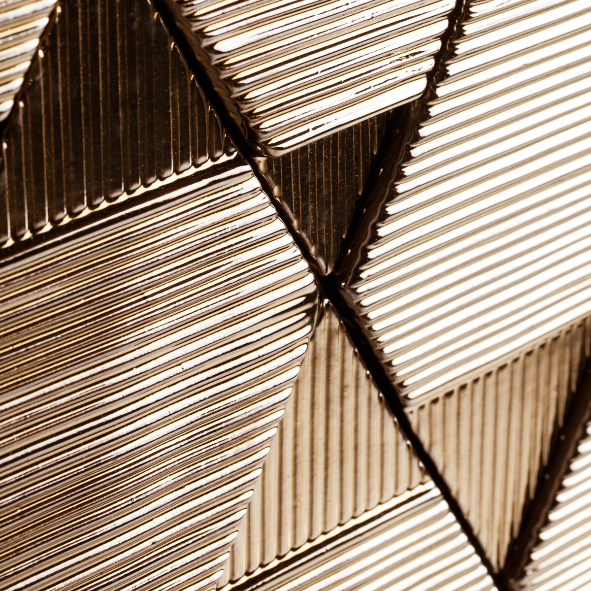 Tua Panel close-up of ribbed bronze-tone triangular tiles