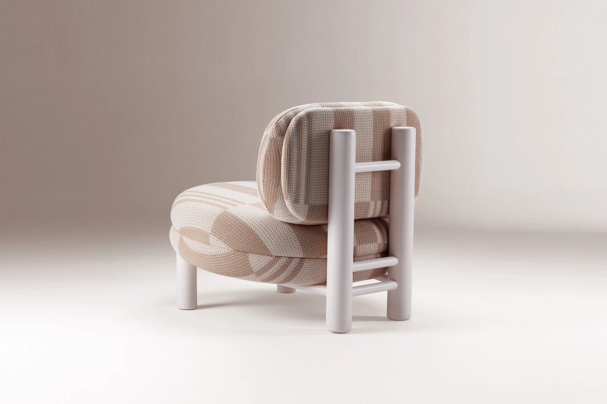 Aimi Lounge Chair in pink striped fabric, back three-quarter view showing the ladder frame