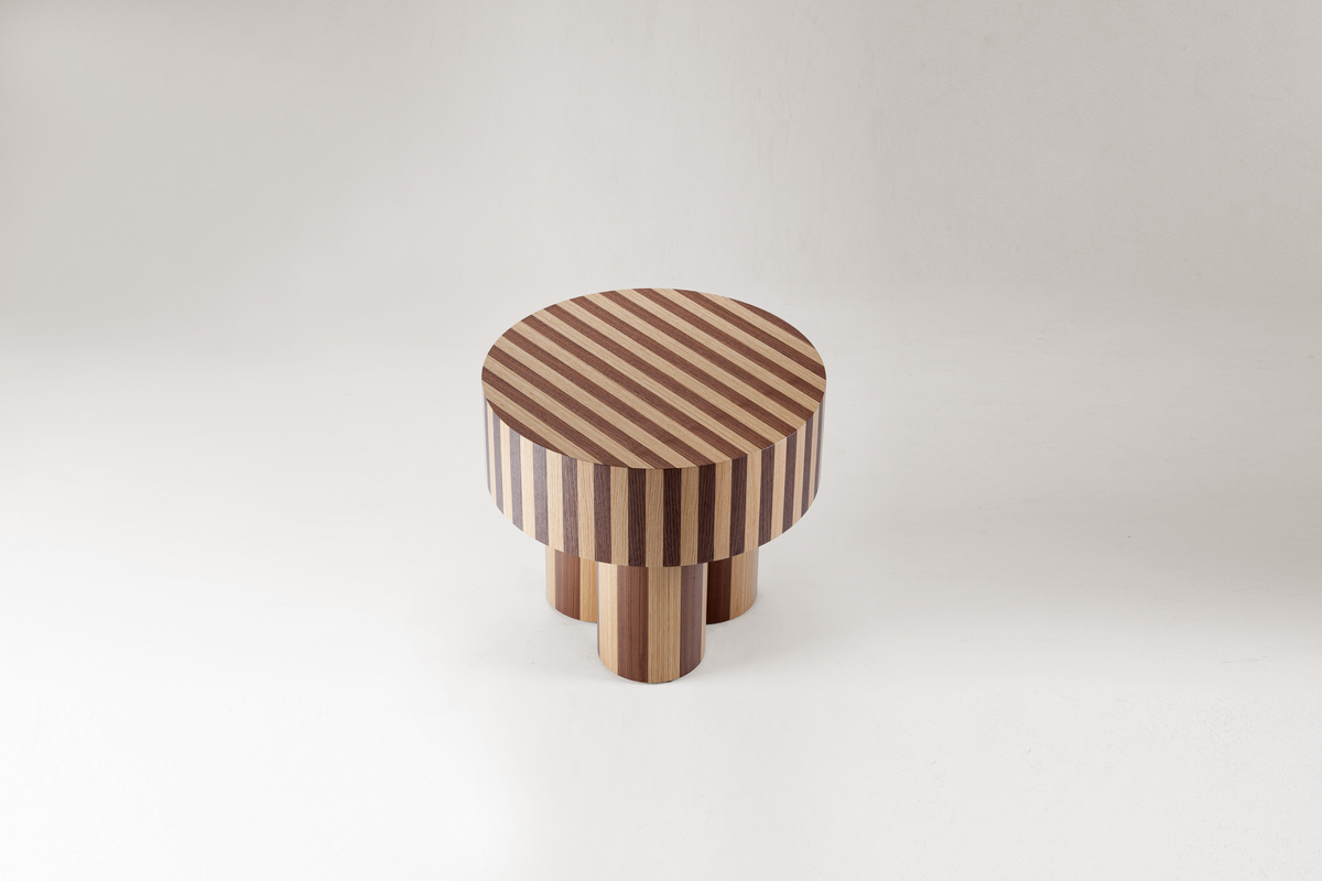Nusa Side Table in striped two-tone wood, side view on grey
