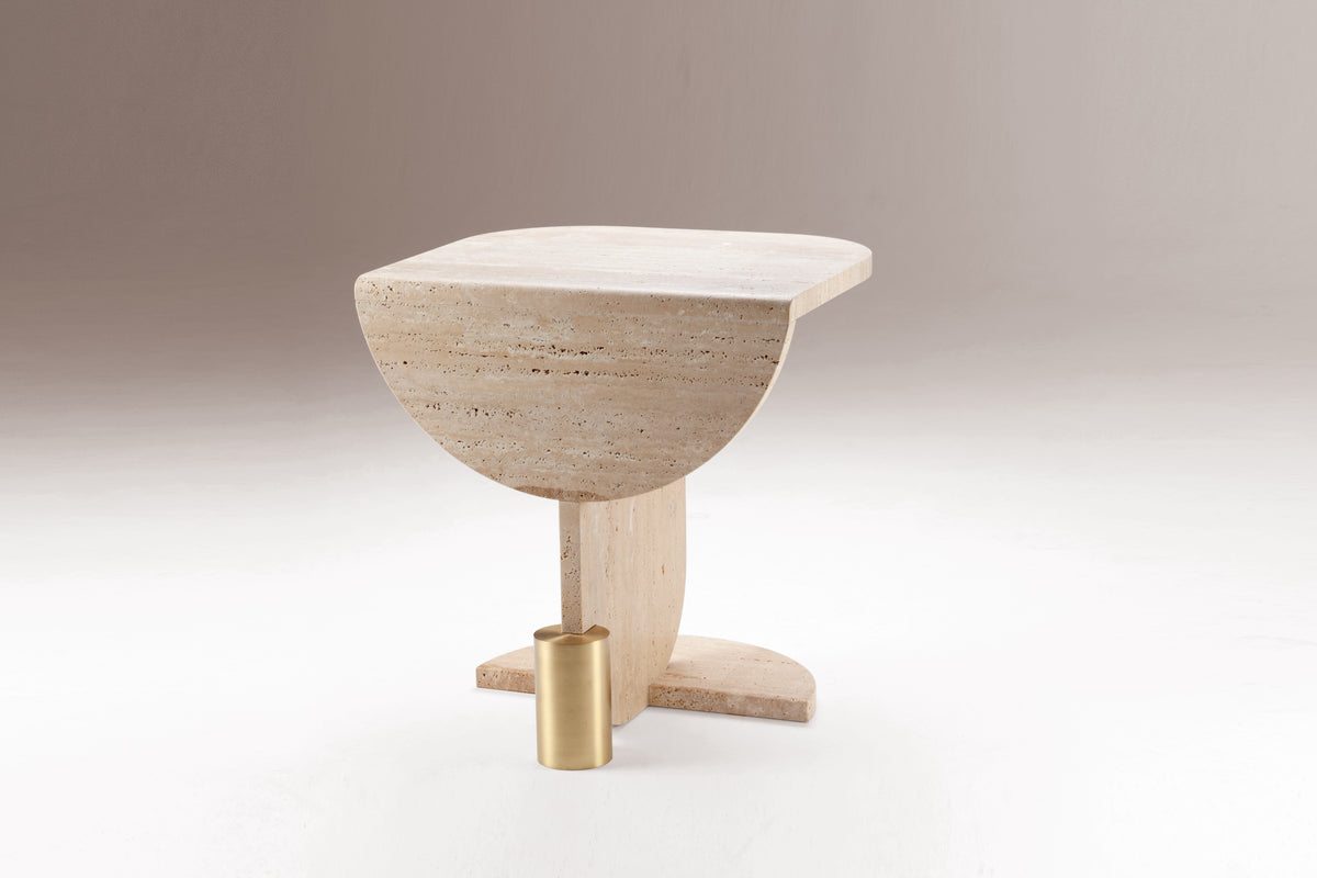 Playing Games Travertine Side Table on a grey backdrop, three-quarter view