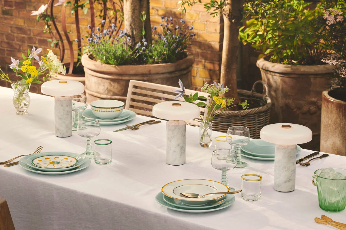 Trip Table Lamp – Carrara | Opal, three lamps along an outdoor dinner table