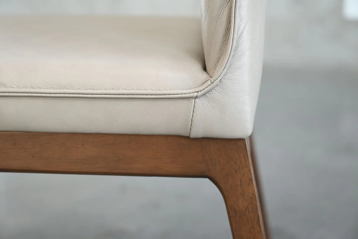 Holt chair side detail where the leather seat meets the wooden frame