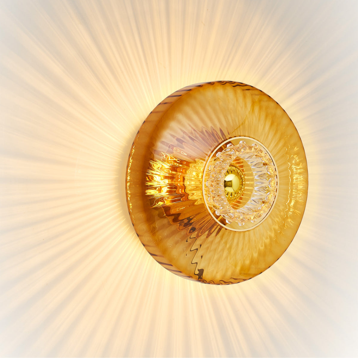 New Wave Optic Wall Sconce XL in amber glass with eyeball insert, angled view lit