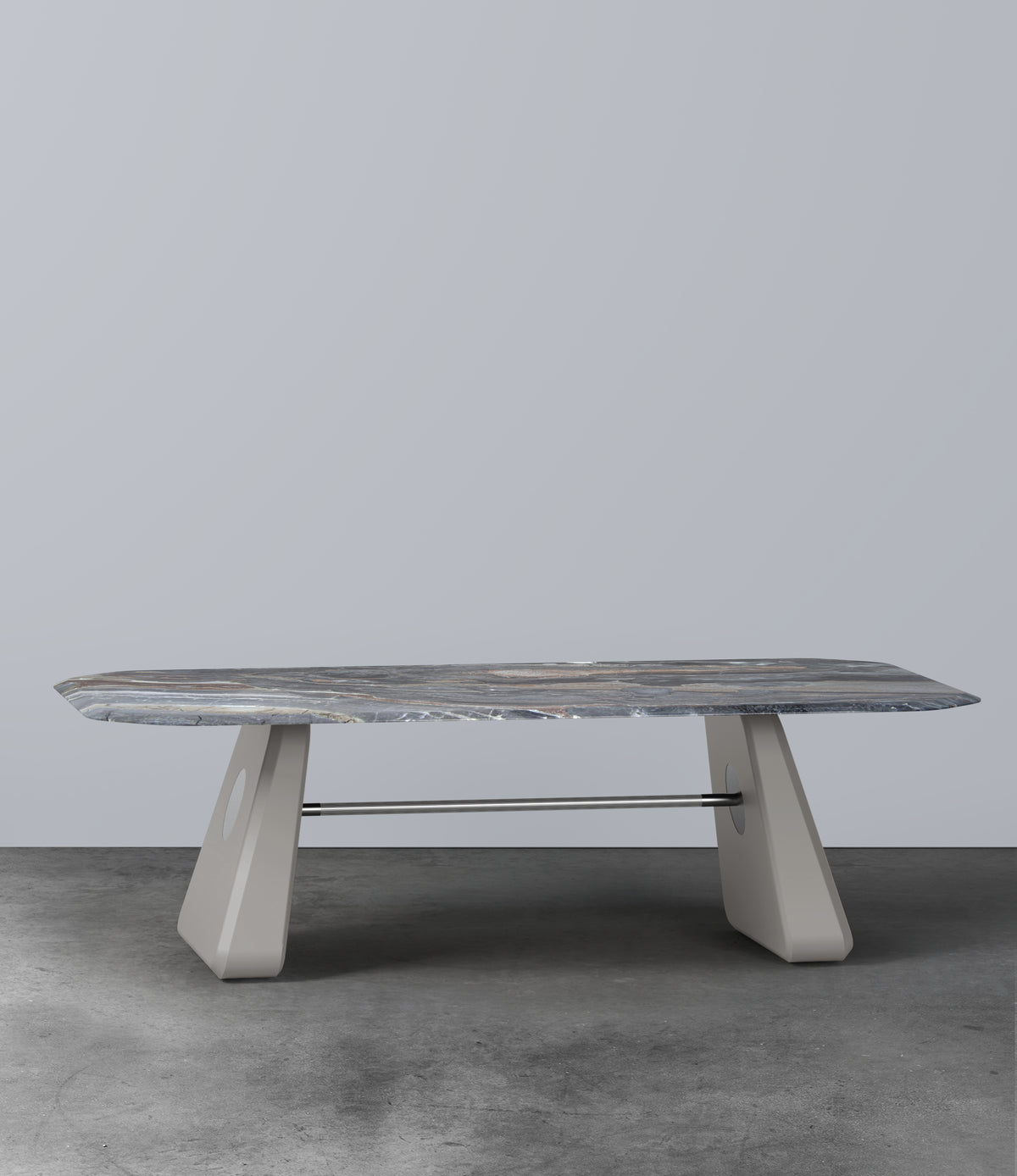 Inge Marble Dining Table with grey marble top and light grey legs on a concrete floor