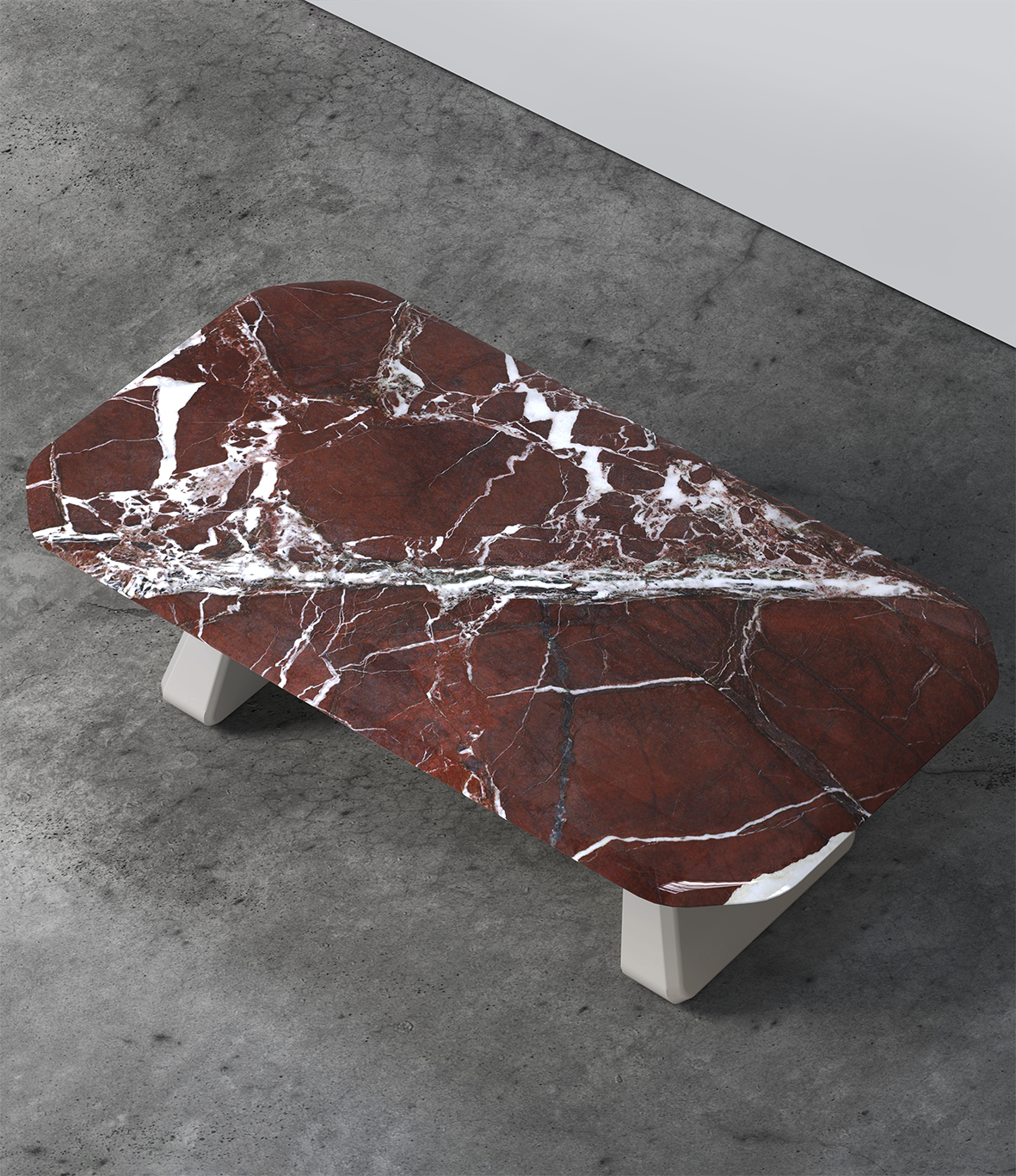 Inge Marble Dining Table with red marble top, overhead view on concrete