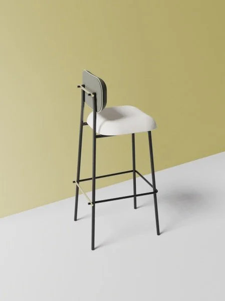 Miami Bar Stool with black frame and white seat against a yellow wall