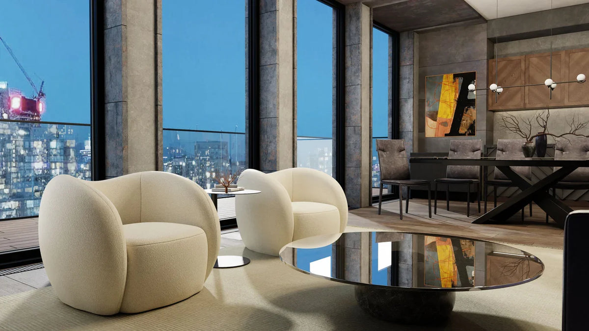 Dune Swivel Lounge Chair pair in Cream Teddy in a high-rise living room at night