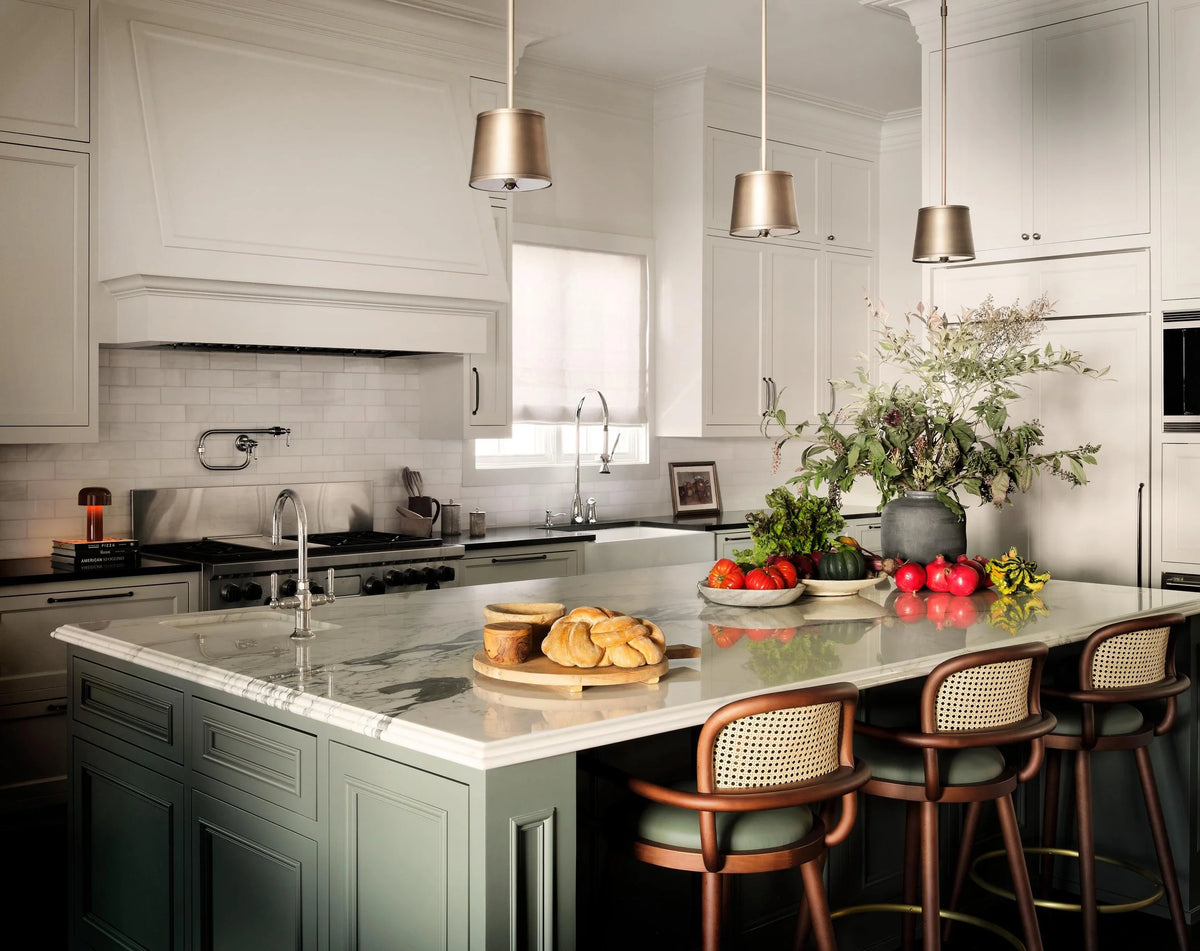 Luc bar chairs at a marble kitchen island with green cabinetry