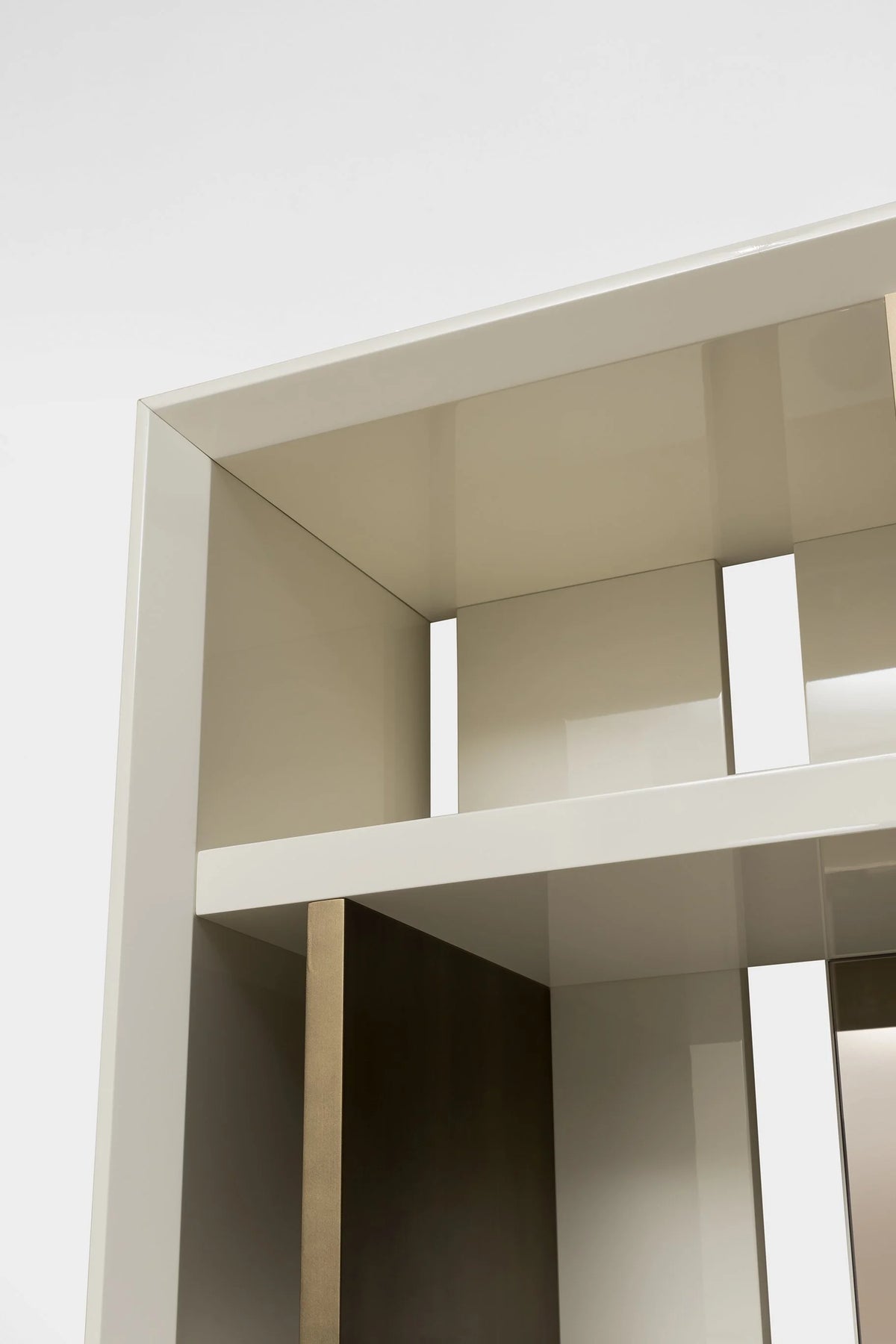 Magritte Bookcase, close-up of the ivory lacquered shelves and bronze dividers