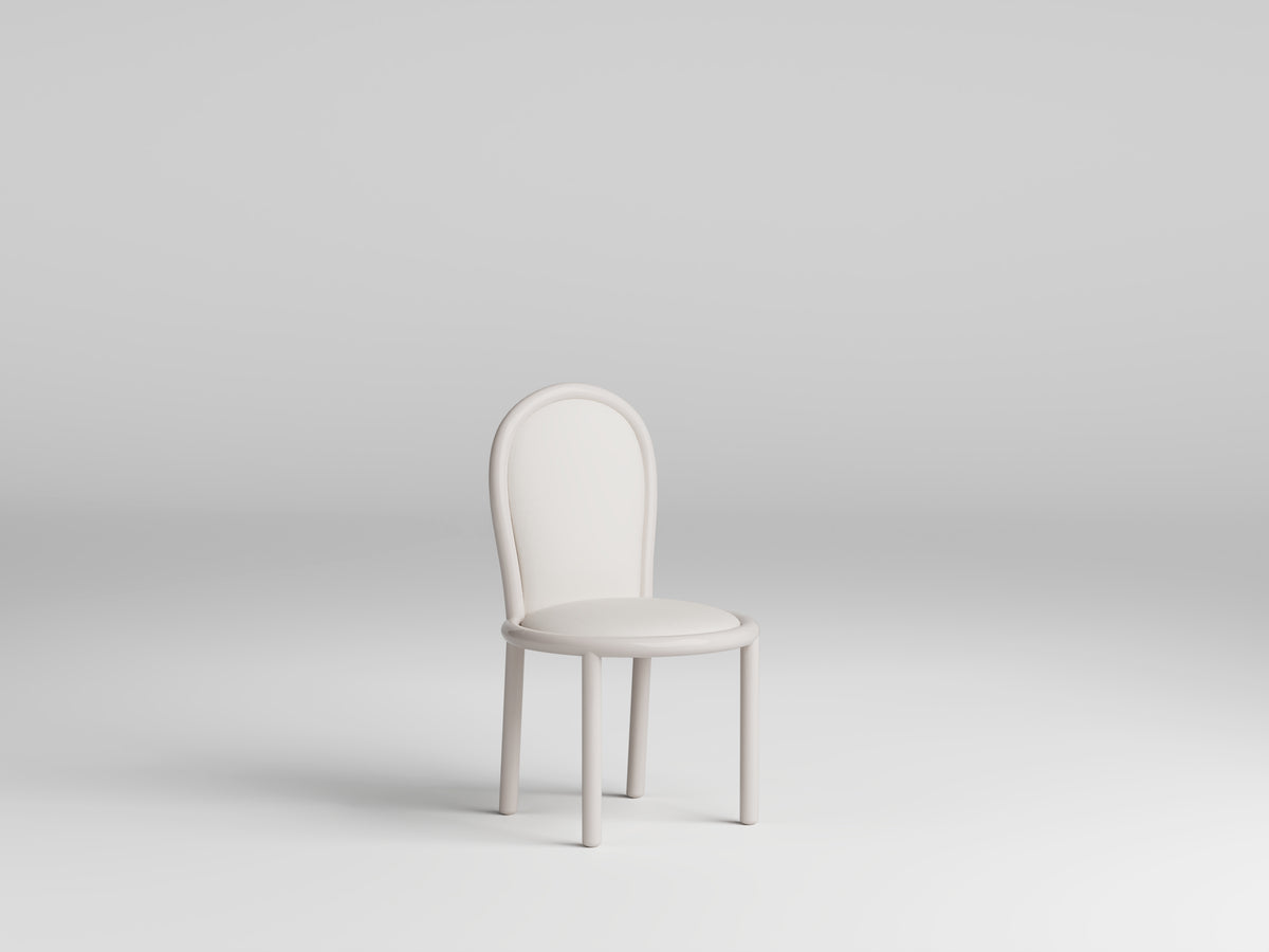 Masa Dining Chair in ivory, three-quarter view on pale grey