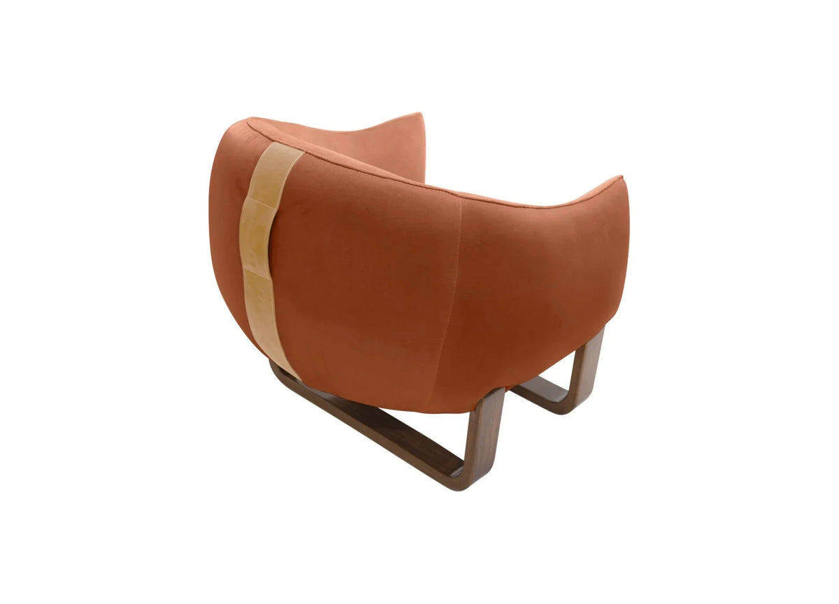 Milo Armchair back view in terracotta velvet with tan leather strap and sled base