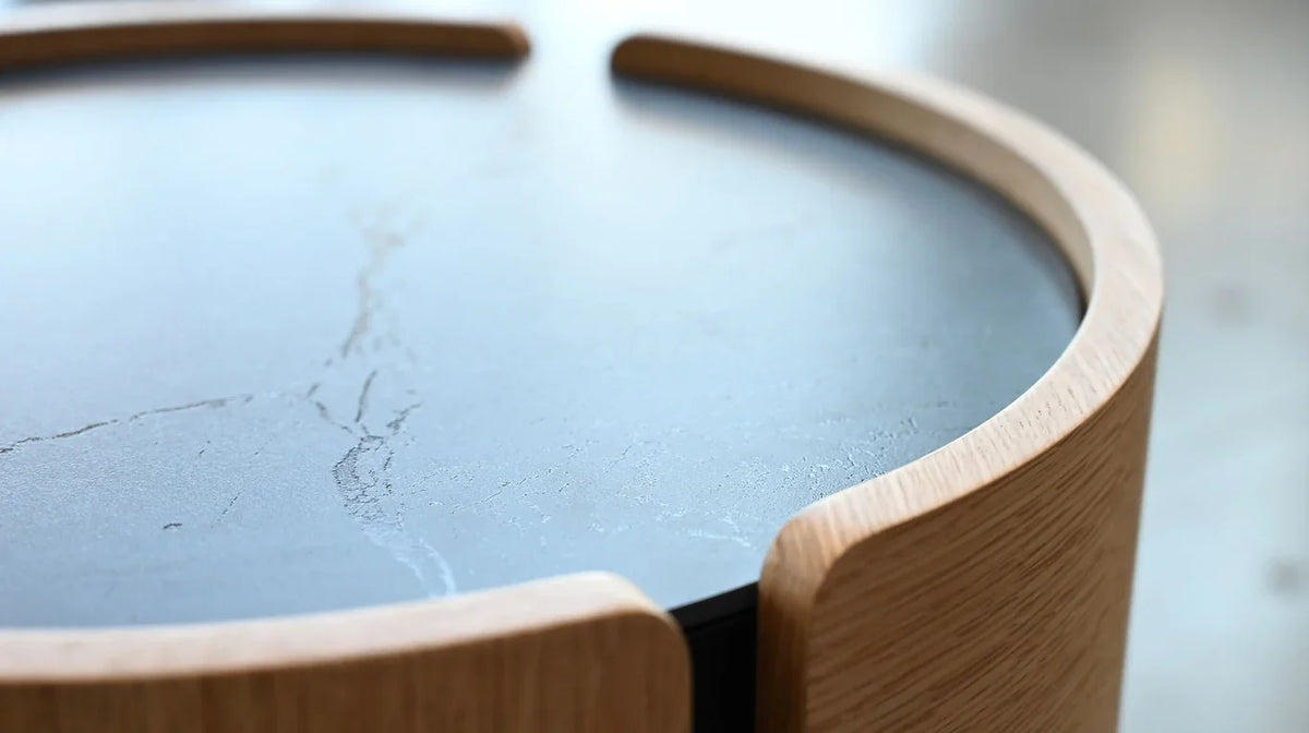 Burrow Night Table close-up of black stone top framed by curved oak