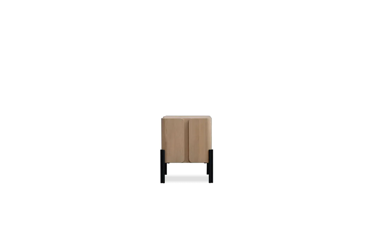 Nori Night Table side view showing steel legs rising over the oak case