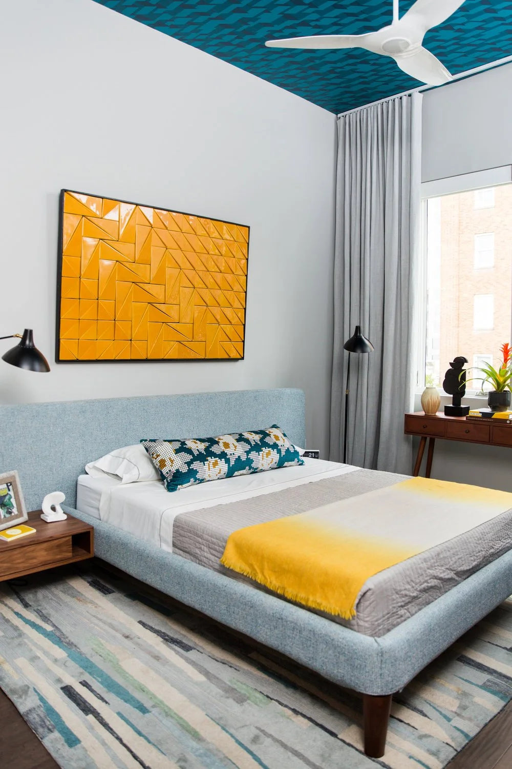 Tejo Panel in Yellow above a bed in a bright bedroom