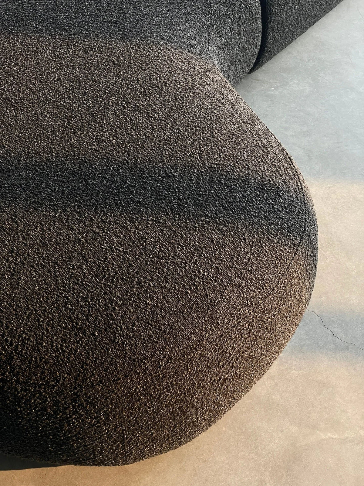 Moritz Sectional in Licorice Boucle, close-up of the nubby boucle texture on the curved arm