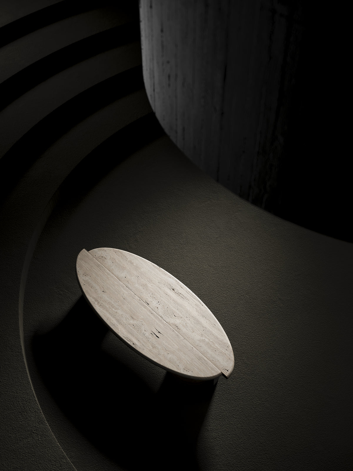 Tayma X Coffee Table in travertine finish on a dark stage, overhead view