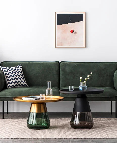 Duverre Coffee Tables in brass-green and black-smoke beside a green sofa