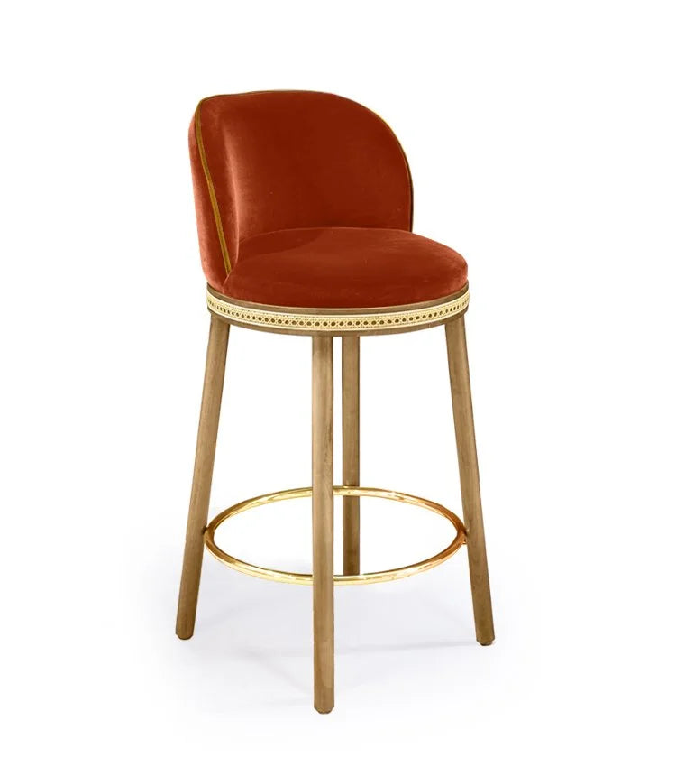 Alma Counter Stool in Fire velvet with natural oak legs and polished brass footrest