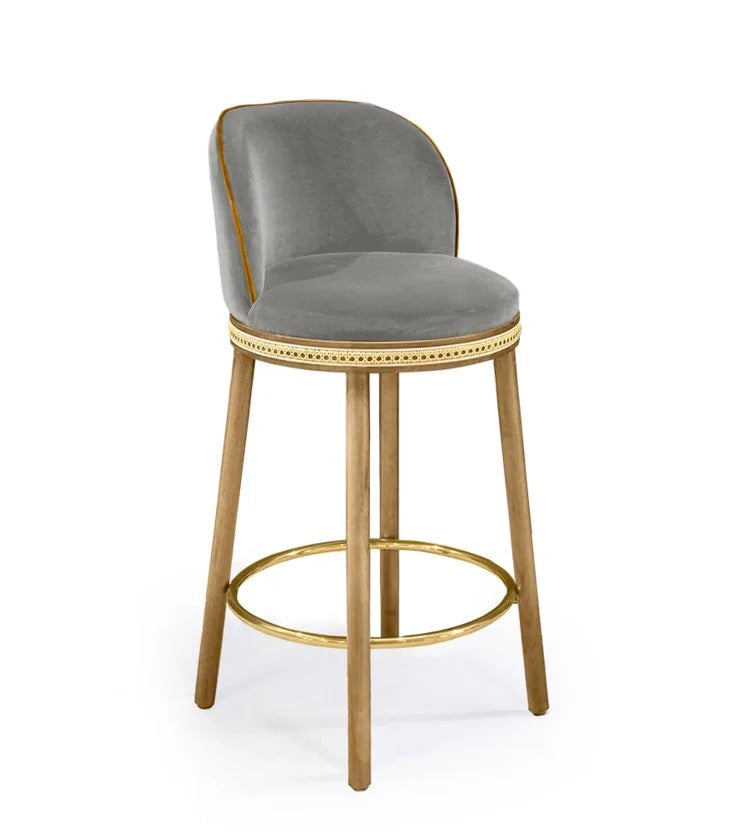 Alma Counter Stool in Fog velvet with natural oak legs and satin brass footrest