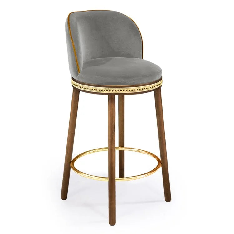 Alma Counter Stool in Fog velvet with natural walnut legs and polished brass footrest