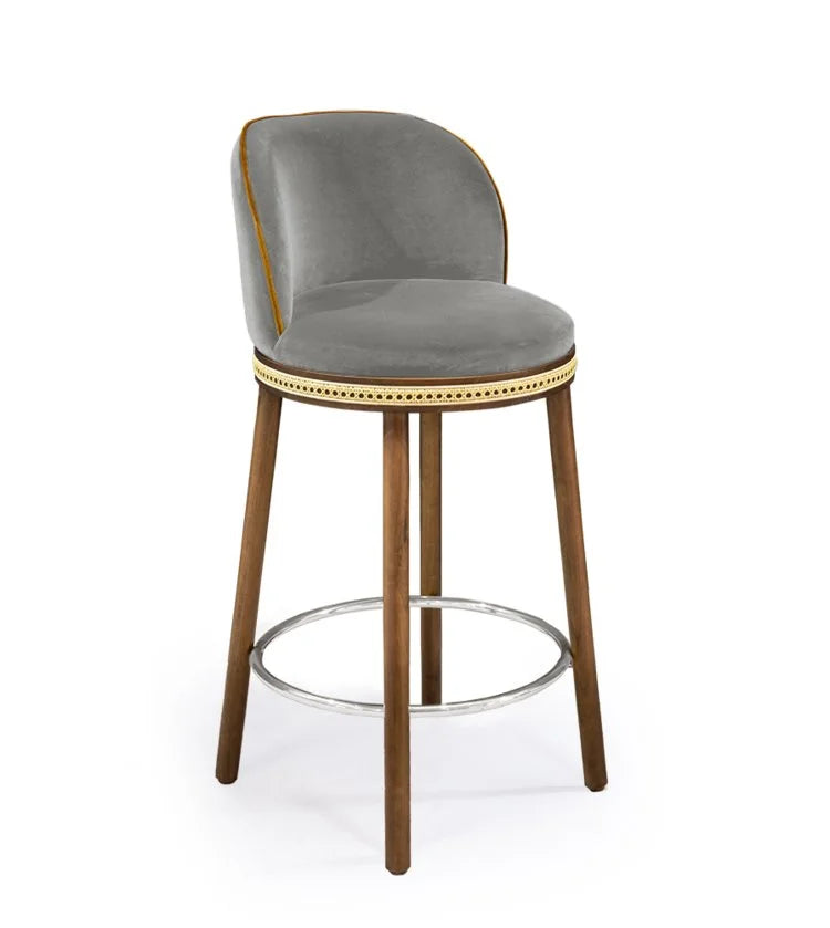 Alma Counter Stool in Fog velvet with natural walnut legs and satin nickel footrest