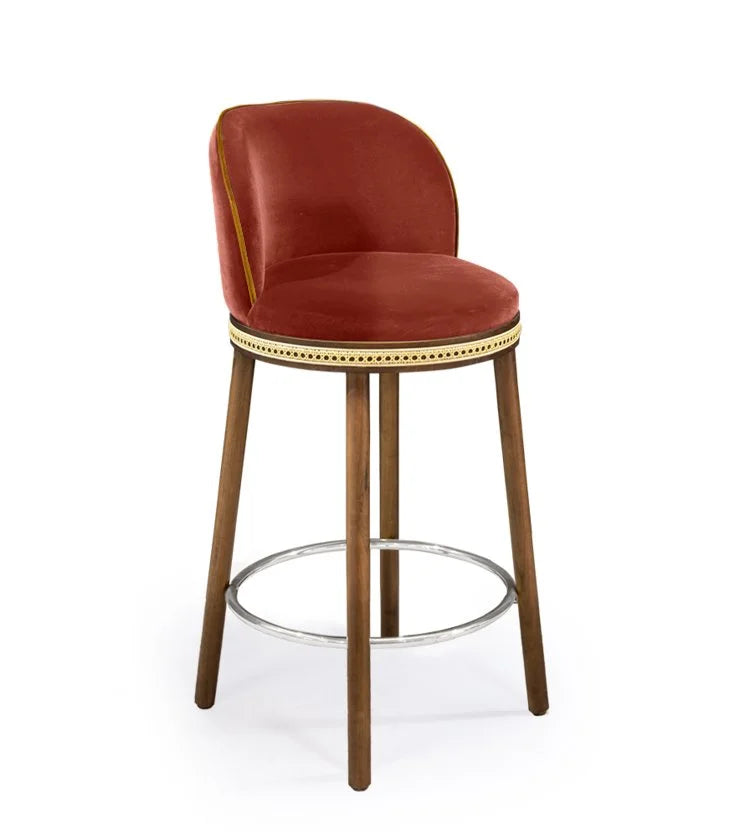 Alma Counter Stool in Peche velvet with natural walnut legs and satin nickel footrest