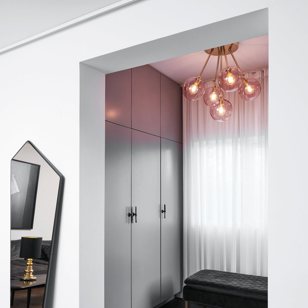 Ballroom Molecule Chandelier with pink glass globes hanging in a dressing room