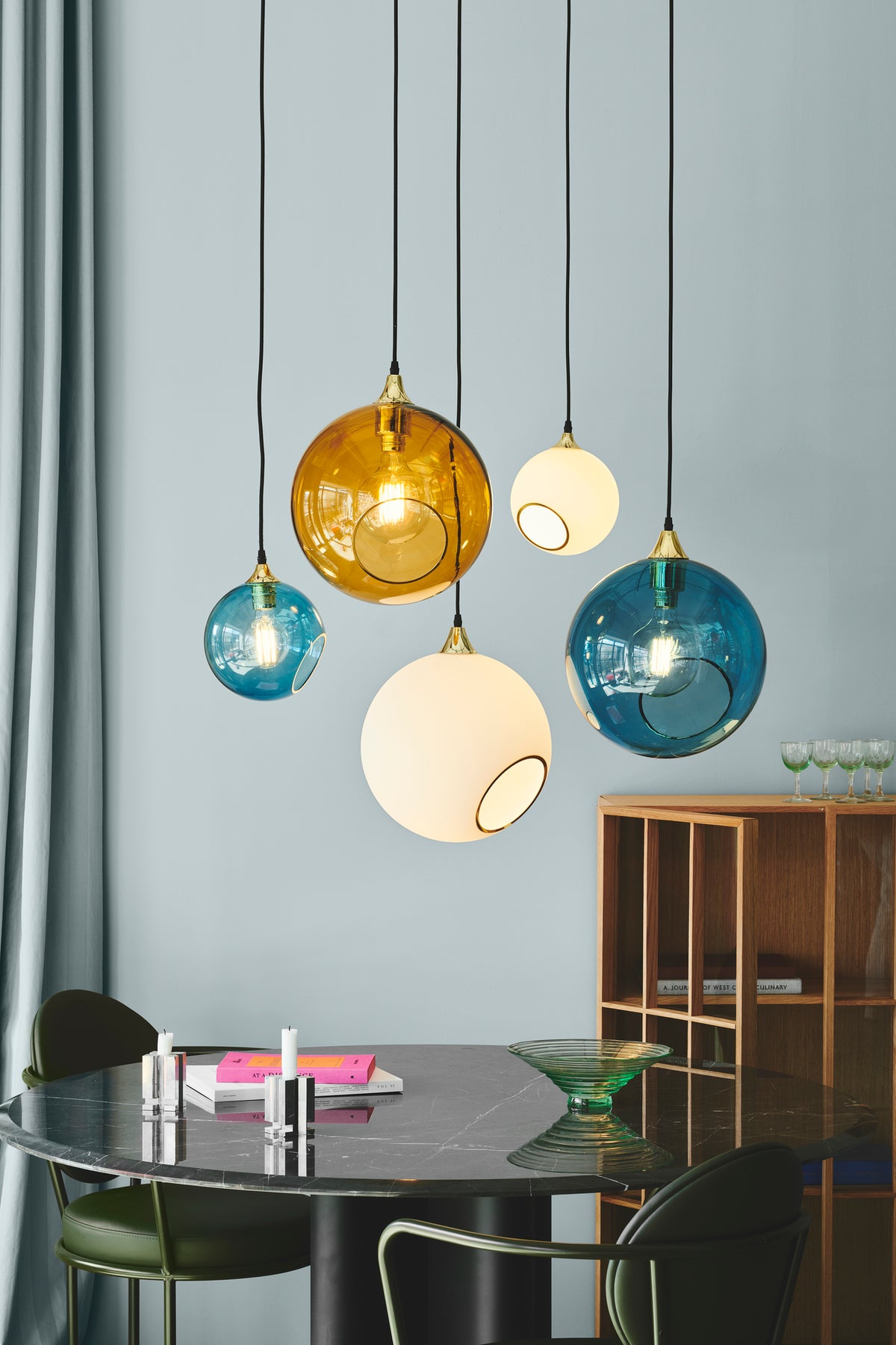 Ballroom Pendant Lights clustered over a dining table by Maison Burgos