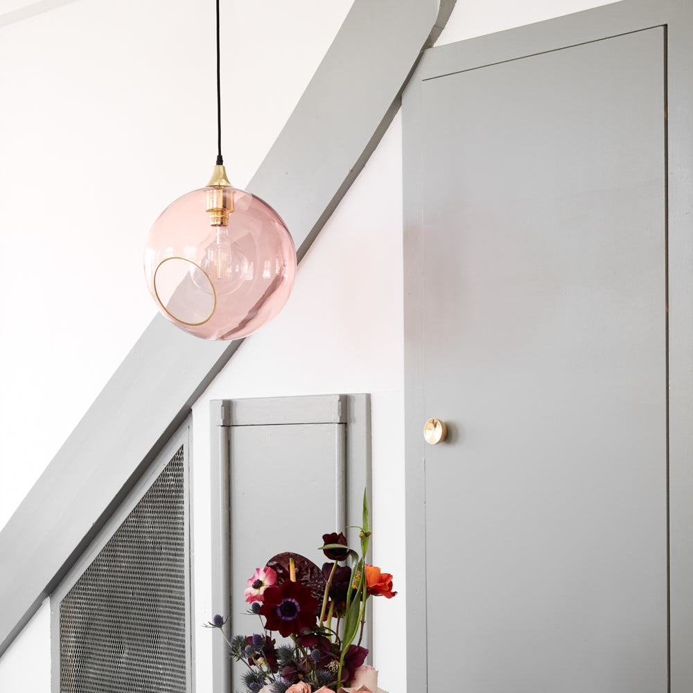 Ballroom Pendant Light XL in pink glass hanging in a grey stairwell