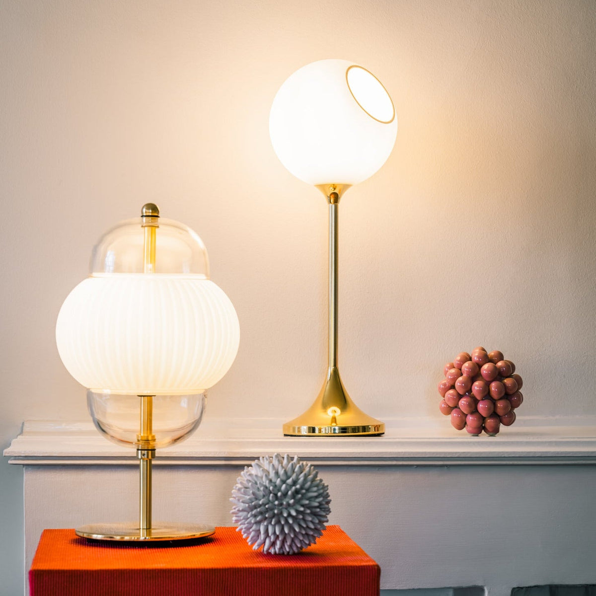 Ballroom Table Lamp tall version in White Snow glass on a red mantel