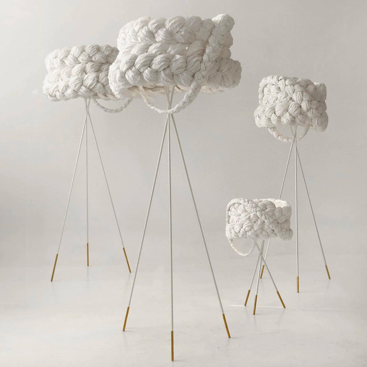 Mammalampa Bride Floor Lamp White - Large with smaller braided tripod lamps in a pale studio