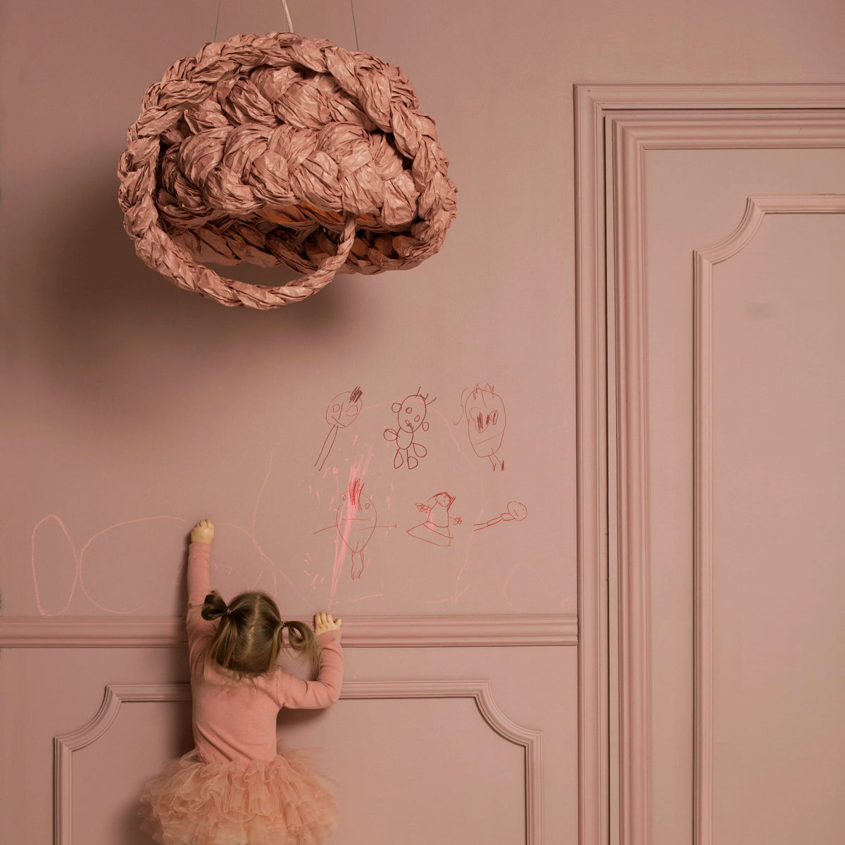 Mammalampa Bride Pendant Light Pink hanging over a girl drawing on a pink wall