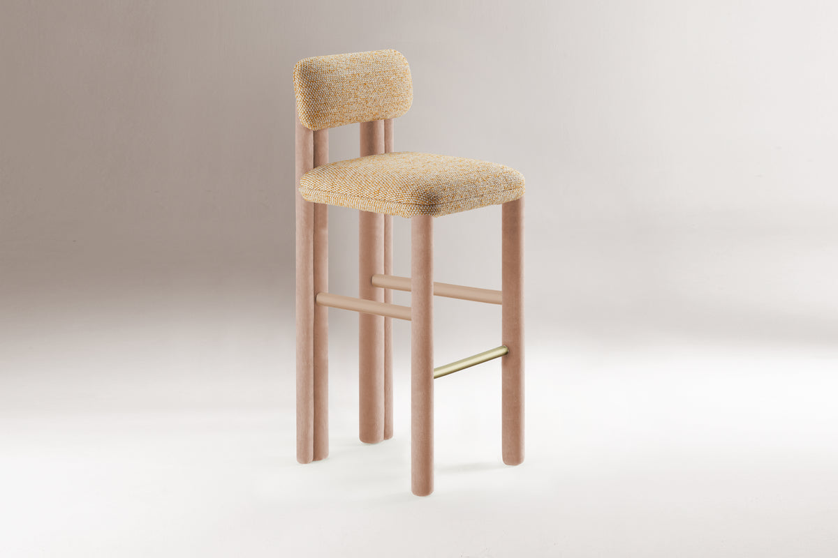 Camelia Counter Stool in beige boucle with blush wood frame and brass footrest on grey