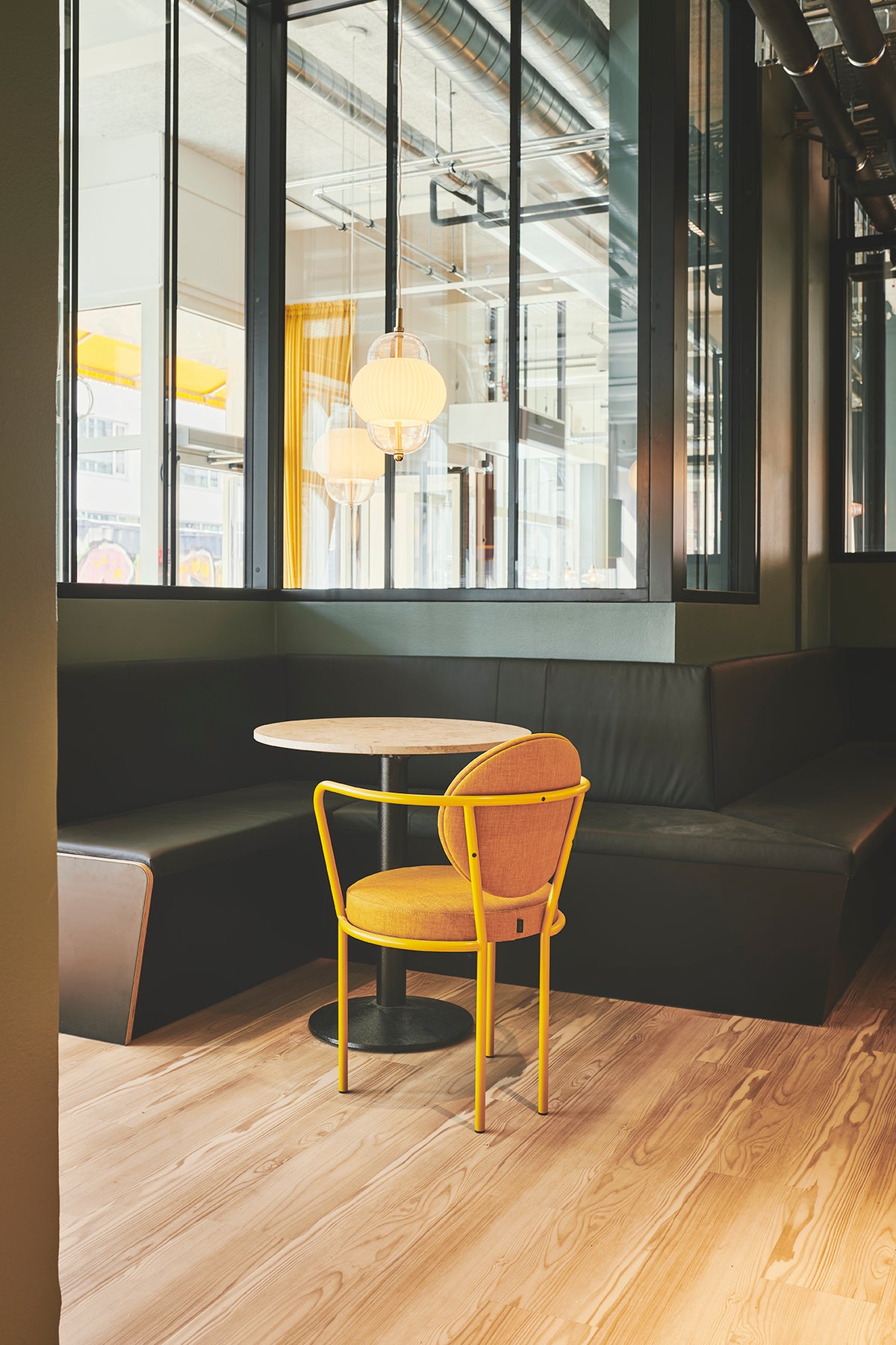 Casablanca Chair with yellow frame at a cafe table by Maison Burgos